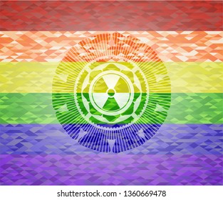 nuclear, radioactive icon inside emblem on mosaic background with the colors of the LGBT flag