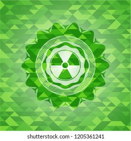 nuclear, radioactive icon inside green emblem with mosaic background