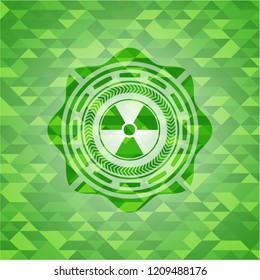 nuclear, radioactive icon inside green emblem with mosaic ecological style background