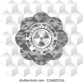 nuclear, radioactive icon inside grey badge with geometric cube white background