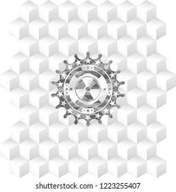 nuclear, radioactive icon inside grey badge with geometric cube white background