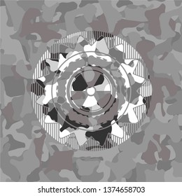 nuclear, radioactive icon inside grey camouflage emblem