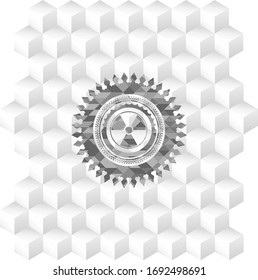 nuclear, radioactive icon inside grey emblem with geometric cube white background