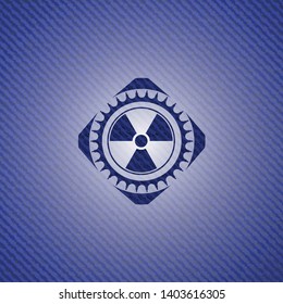 nuclear, radioactive icon inside jean or denim emblem or badge background