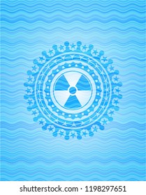 nuclear, radioactive icon inside light blue water style badge.