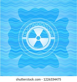 nuclear, radioactive icon inside light blue water emblem background.