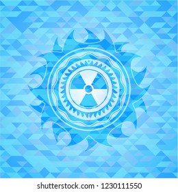 nuclear, radioactive icon inside light blue emblem with mosaic ecological style background