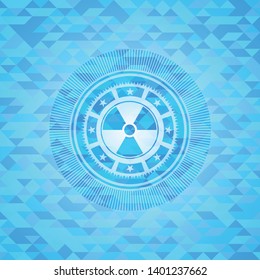 nuclear, radioactive icon inside light blue emblem with mosaic background