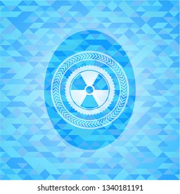 nuclear, radioactive icon inside realistic light blue emblem. Mosaic background