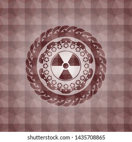nuclear, radioactive icon inside red seamless emblem or badge with geometric pattern background.