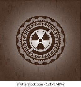 nuclear, radioactive icon inside retro wooden emblem