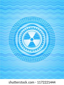 nuclear, radioactive icon inside sky blue water style badge.
