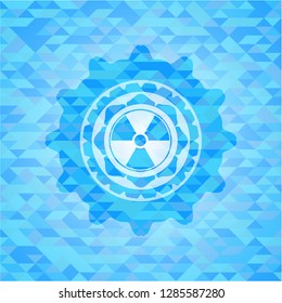 nuclear, radioactive icon inside sky blue emblem with triangle mosaic background