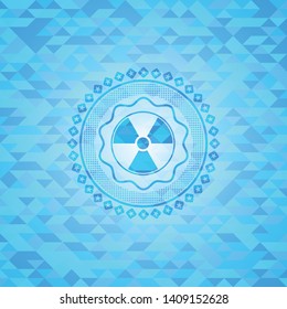 nuclear, radioactive icon inside sky blue emblem with triangle mosaic background