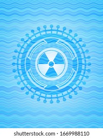 nuclear, radioactive icon inside sky blue water wave badge background.