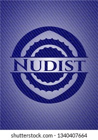 Nudist badge with denim background