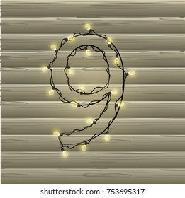 Number from the Christmas light garland on a beautiful wooden background