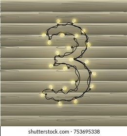 Number from the Christmas light garland on a beautiful wooden background