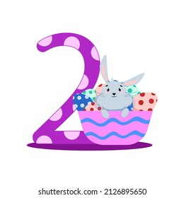number two with a gray bunny sitting in a basket with eggs
