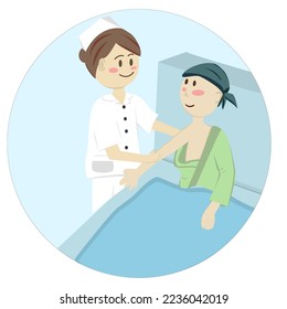 A nurse is feeding a cancer patient who is lying in bed.