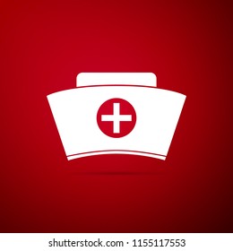 Nurse hat with cross icon isolated on red background. Medical nurse cap sign. Flat design. Vector Illustration