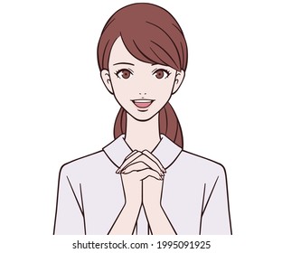 A nurse holding hands in front of her chest