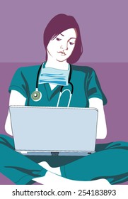 Nurse sitting cross-legged and using laptop