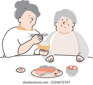 Nursing staff assisting the elderly with meals