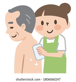 Nursing staff wiping the body of an elderly man with a towel