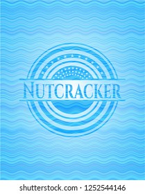 Nutcracker light blue water wave badge.