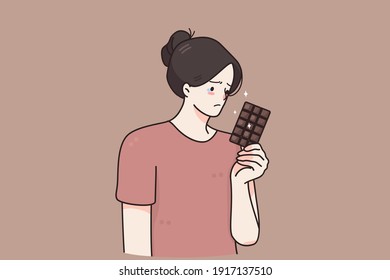 Nutrition, restrictions, diet concept. Sad unhappy young woman cartoon character standing with chocolate in hand tired of diet restrictions feeling guilty vector illustration 