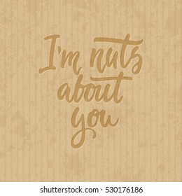 I'm nuts about you - hand drawn lettering phrase isolated on the cardboard grunge background. Fun brush ink inscription for photo overlays, greeting card or t-shirt print, poster design.