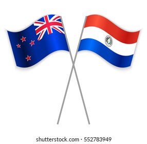NZ and Paraguayan crossed flags. New Zealand combined with Paraguay isolated on white. Language learning, international business or travel concept.