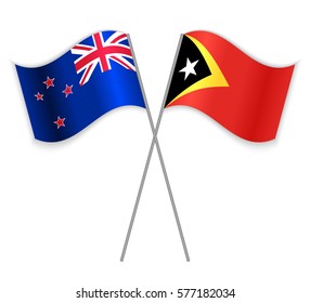 NZ and Timorese crossed flags. New Zealand combined with East Timor isolated on white. Language learning, international business or travel concept.