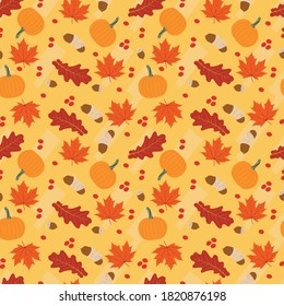 Oak and maple leaves, Acorns and berries and pumpkins seamless pattern to show the beauty of Autumn colors.