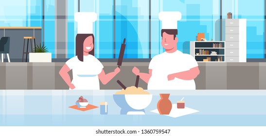 Obese Cooks Couple Preparing Tasty Meals Overweight Man Woman Chefs In Uniform Cooking Together Modern Kitchen Interior Restaurant Workers Team Horizontal Portrait