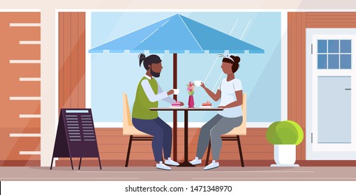 obese couple sitting at table eating sweet cake overweight african american man woman spending time together unhealthy nutrition obesity concept modern street cafe exterior full length horizontal