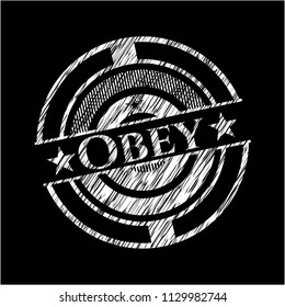 Obey chalkboard emblem written on a blackboard
