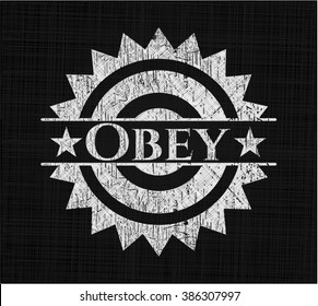 Obey chalkboard emblem written on a blackboard