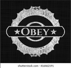 Obey chalkboard emblem written on a blackboard