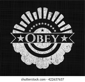 Obey chalkboard emblem written on a blackboard