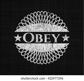 Obey chalkboard emblem written on a blackboard