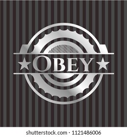 Obey silvery emblem or badge