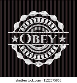 Obey silvery emblem or badge