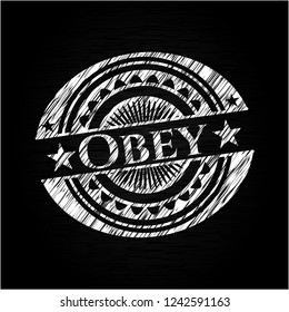 Obey written on a chalkboard