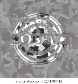 Obey written on a grey camouflage texture