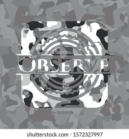 [object OObserve written on a grey camouflage texturebject]