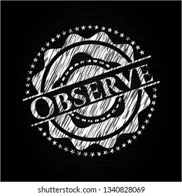 Observe chalk emblem written on a blackboard
