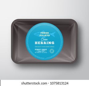 Ocean Herring Fillets. Abstract Vector Fish Plastic Tray with Cellophane Cover Packaging Design Round Label or Sticker. Retro Typography and Hand Drawn Herring Silhouette Background Layout. Isolated.