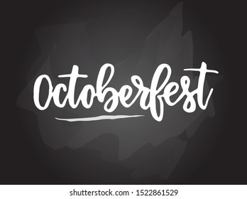 Octoberfest - handwritten modern calligraphy handlettering typography on blackboard (chalkboard) background. Octoberfest traditional festival concept illustration.